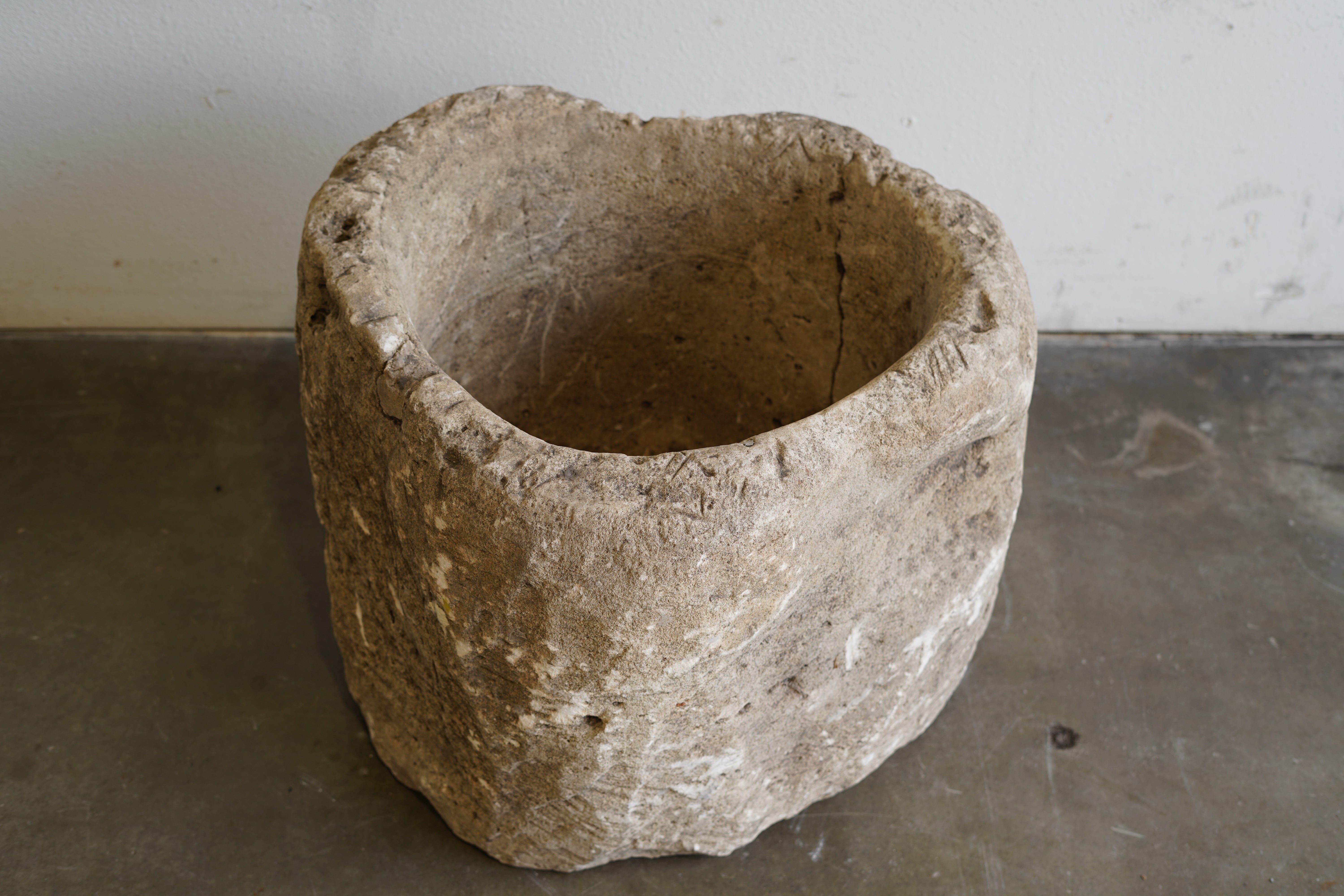 Antique Limestone Planter with natural aging, character, nail holes, uneven edge.&nbsp;

24" D x 20" H