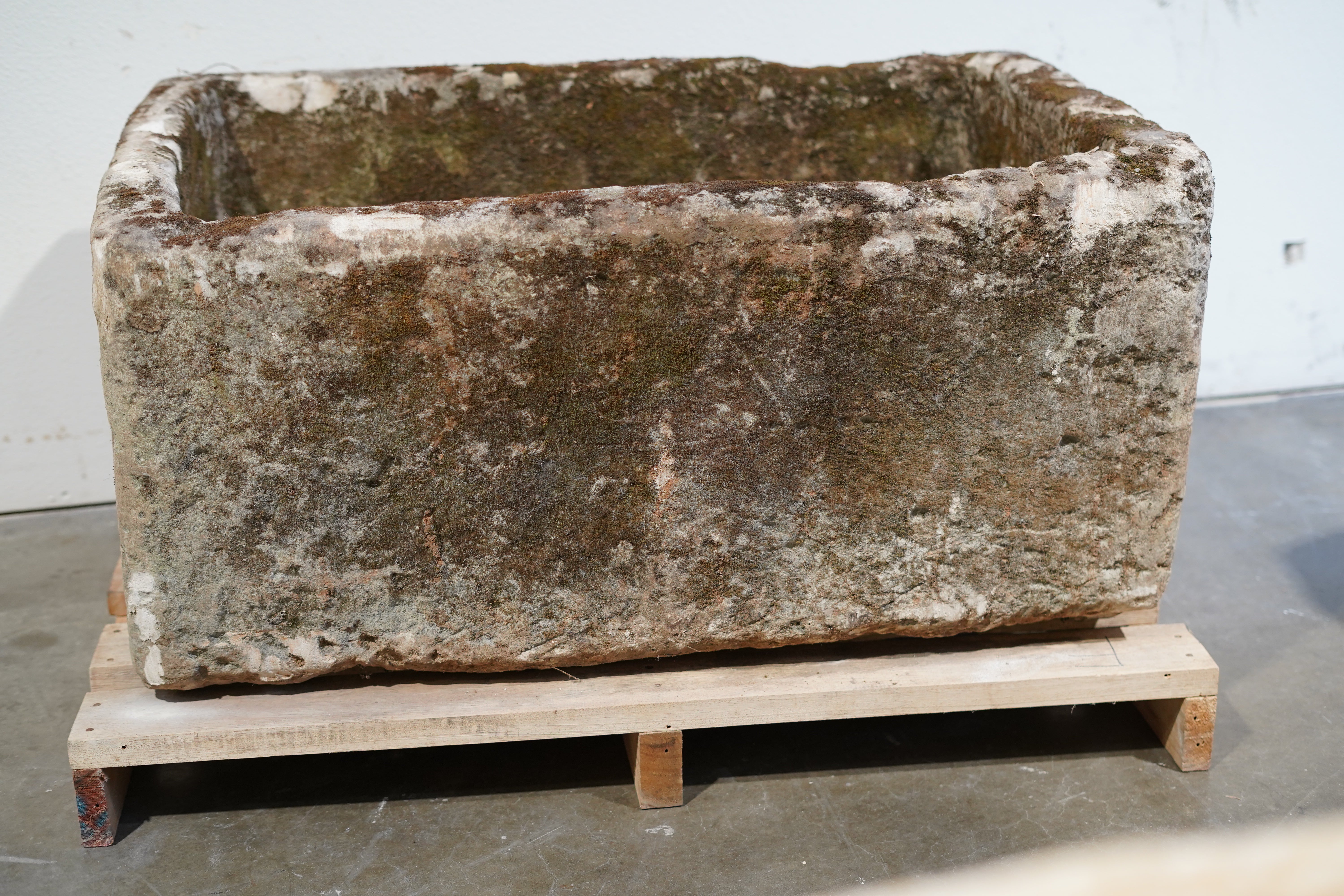 limestone trough with natural aging and wear and tear.