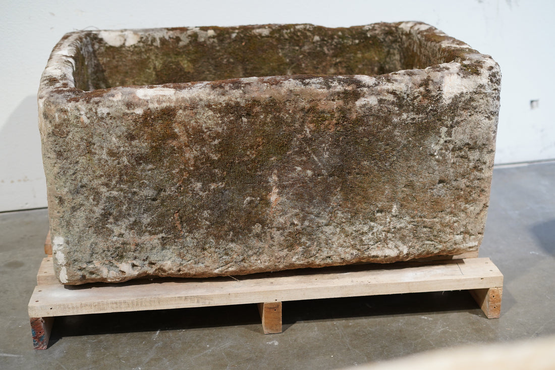 limestone trough with natural aging and wear and tear.