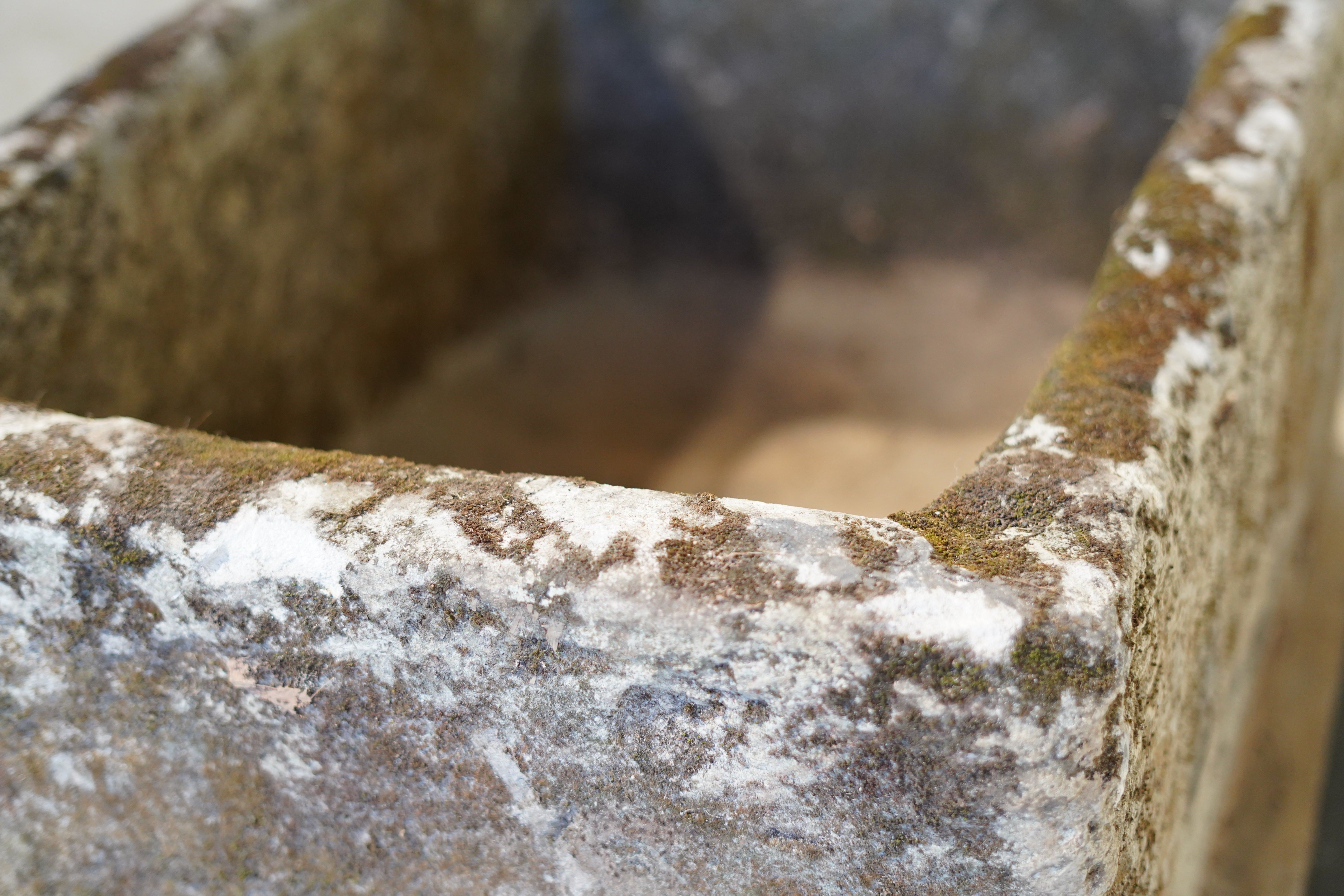 side close up of natural aging and patina on limestone trough