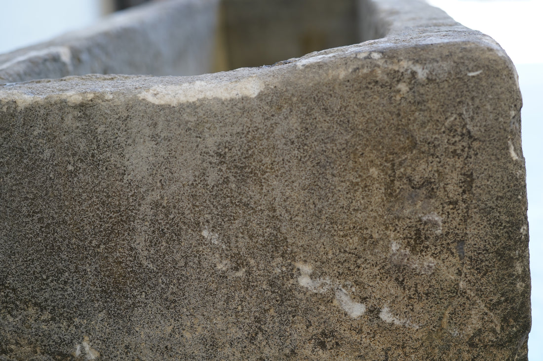 Side close up of antique limestone trough