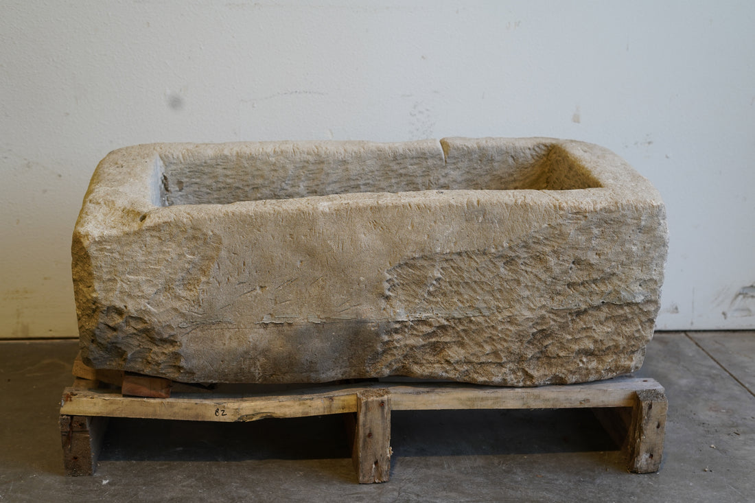 Wide angle of limestone planter showcasing full rectangular shape and aged character