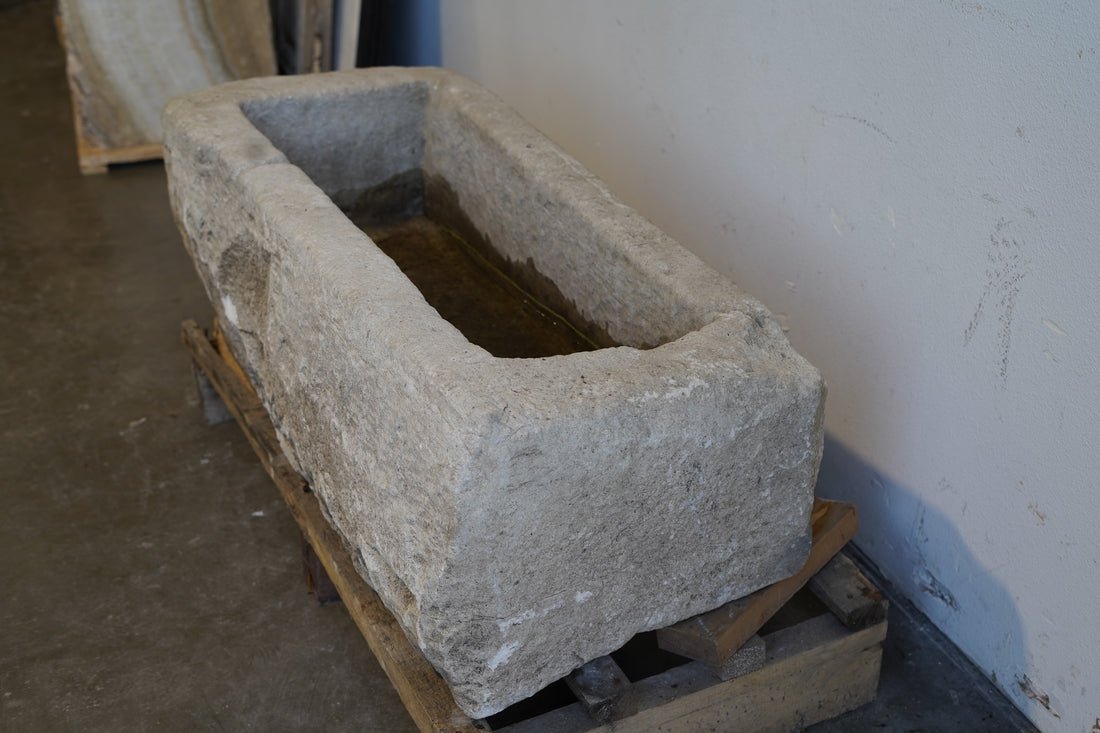 Top view of antique limestone planter highlighting interior depth and drainage hole