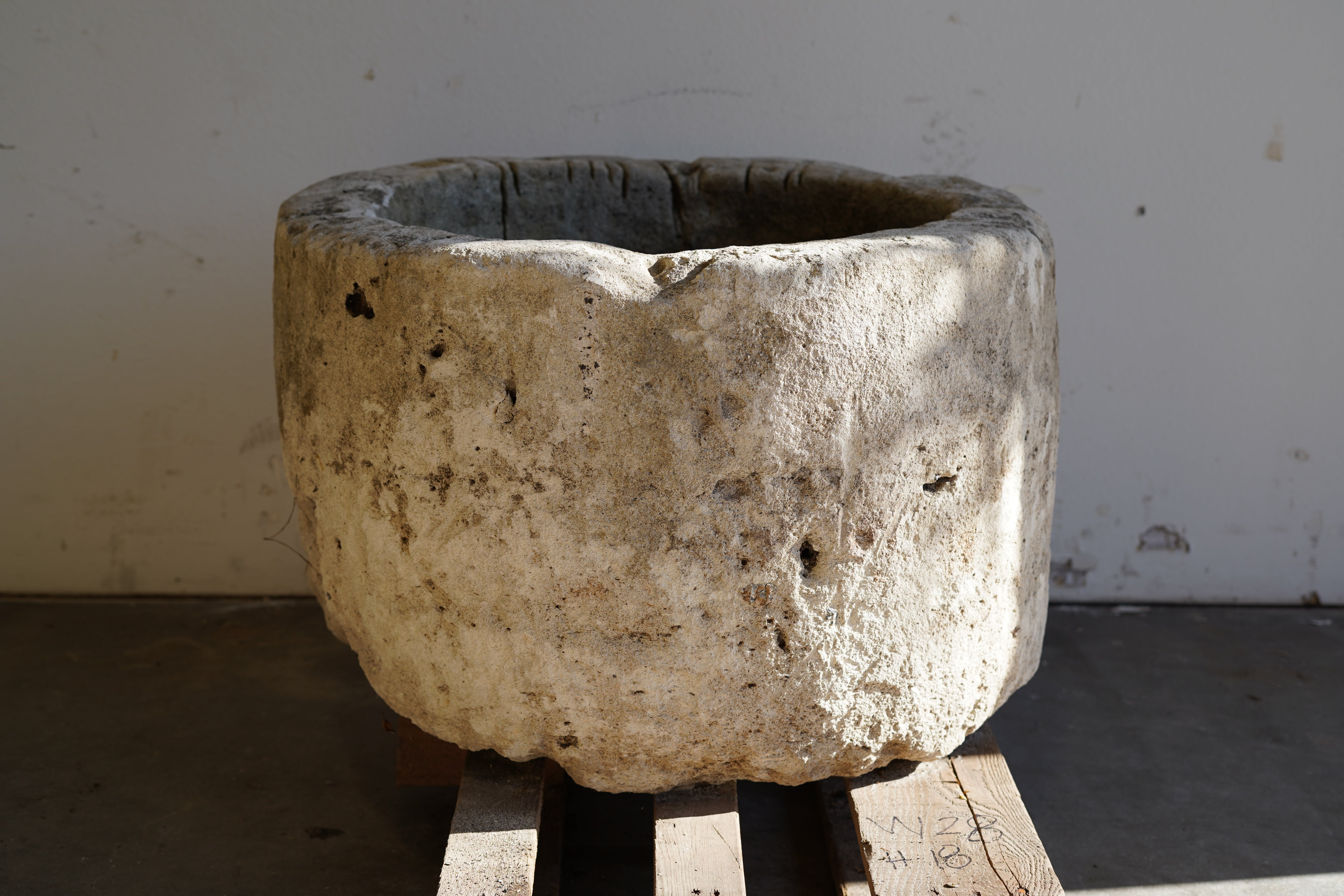 Antique Limestone Planter - Round. Dimensions: 18" H x 28" W. Natural sunlight.