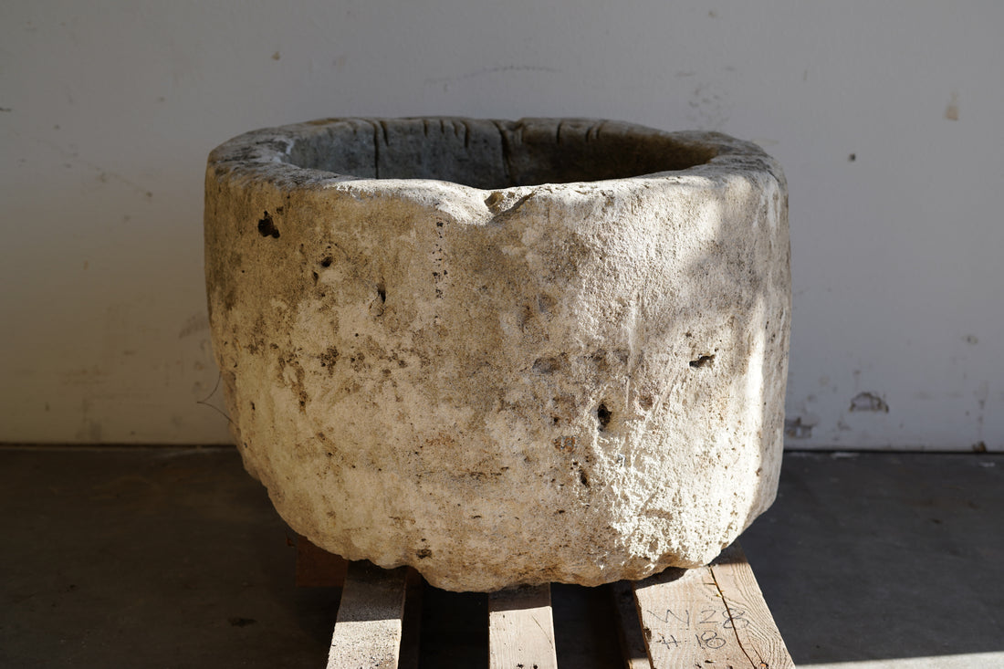 Antique Limestone Planter - Round. Dimensions: 18" H x 28" W. Natural sunlight.