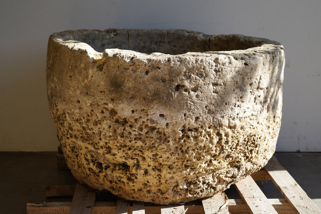 Natural patina and aging on an extra large wide, antique hand-carved limestone planter.