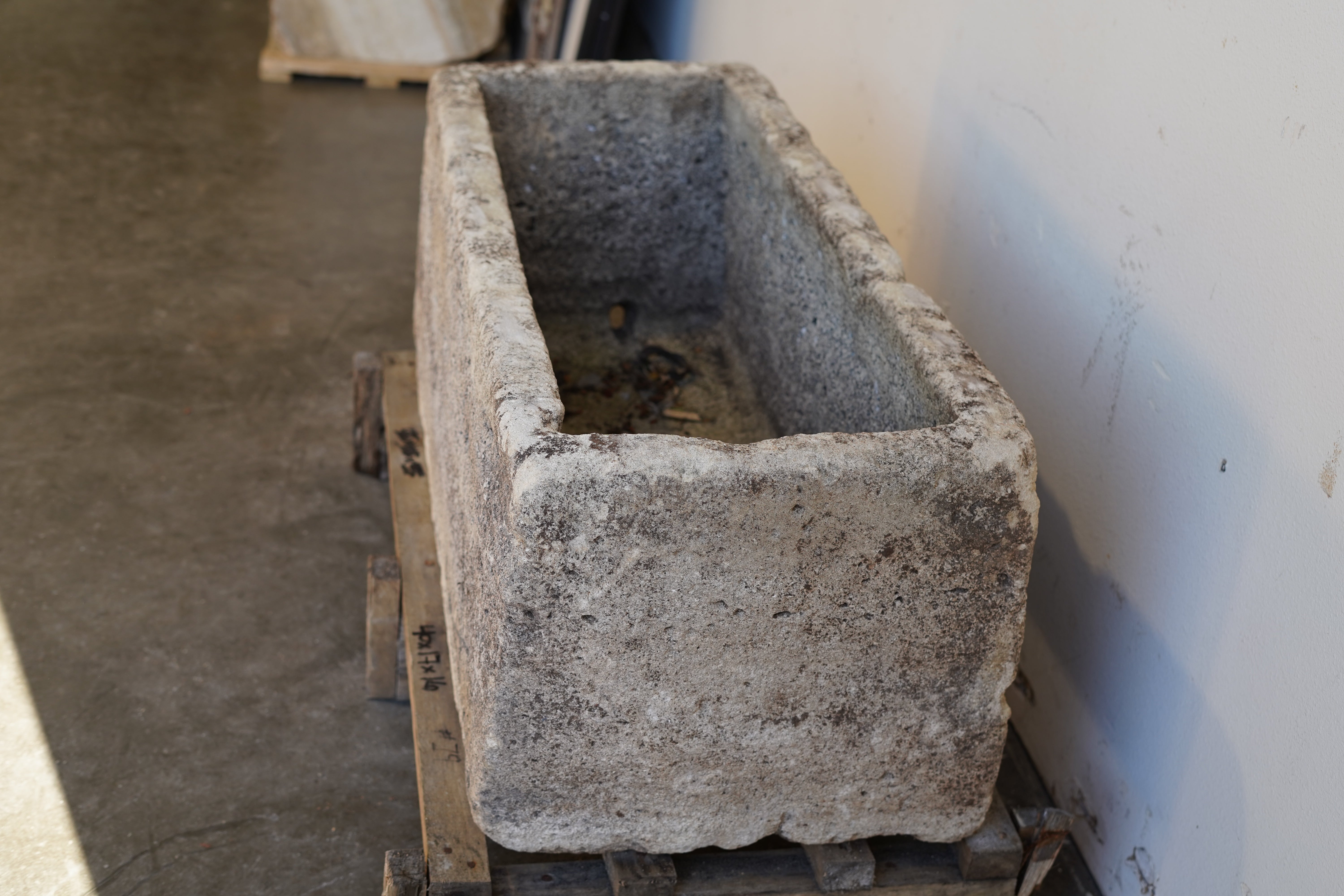 Side view of Antique Authentic Limestone Rectangular Square Planter 40" L x 17" W x 16" H with natural Patina in indoor lighting.