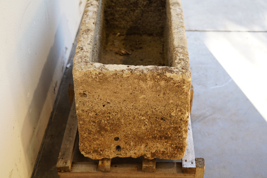 Side view of Antique Authentic Limestone Rectangular Square Planter 40" L x 17" W x 16" H with natural Patina in natural sunlight.