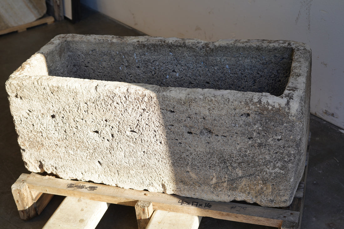 Front view of Antique Authentic Limestone Rectangular Square Planter 40" L x 17" W x 16" H with natural Patina in partial natural sunlight and partial shade.
