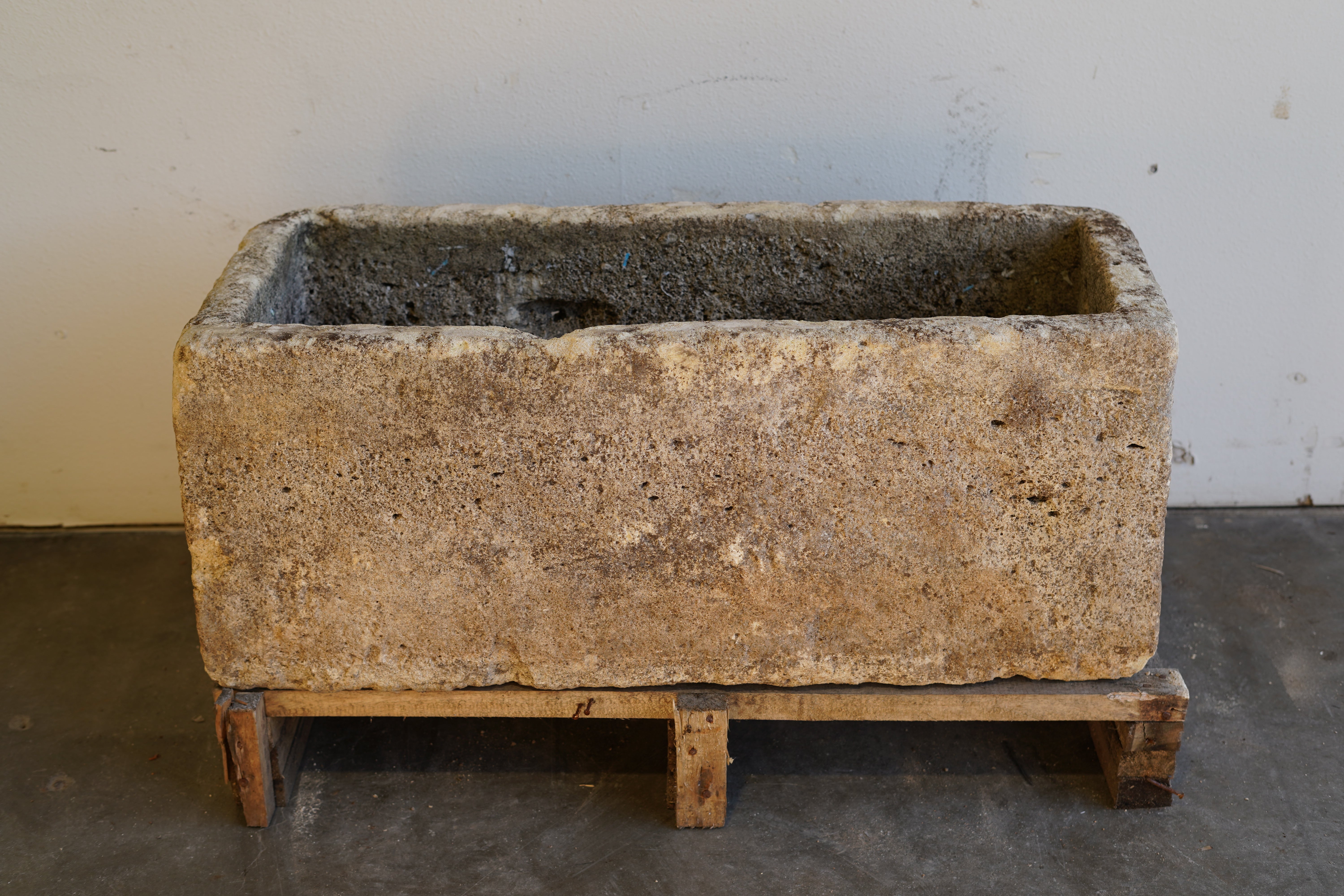 Front view of Antique Authentic Limestone Rectangular Square Planter 40" L x 17" W x 16" H with natural Patina in indoor lighting/shade.