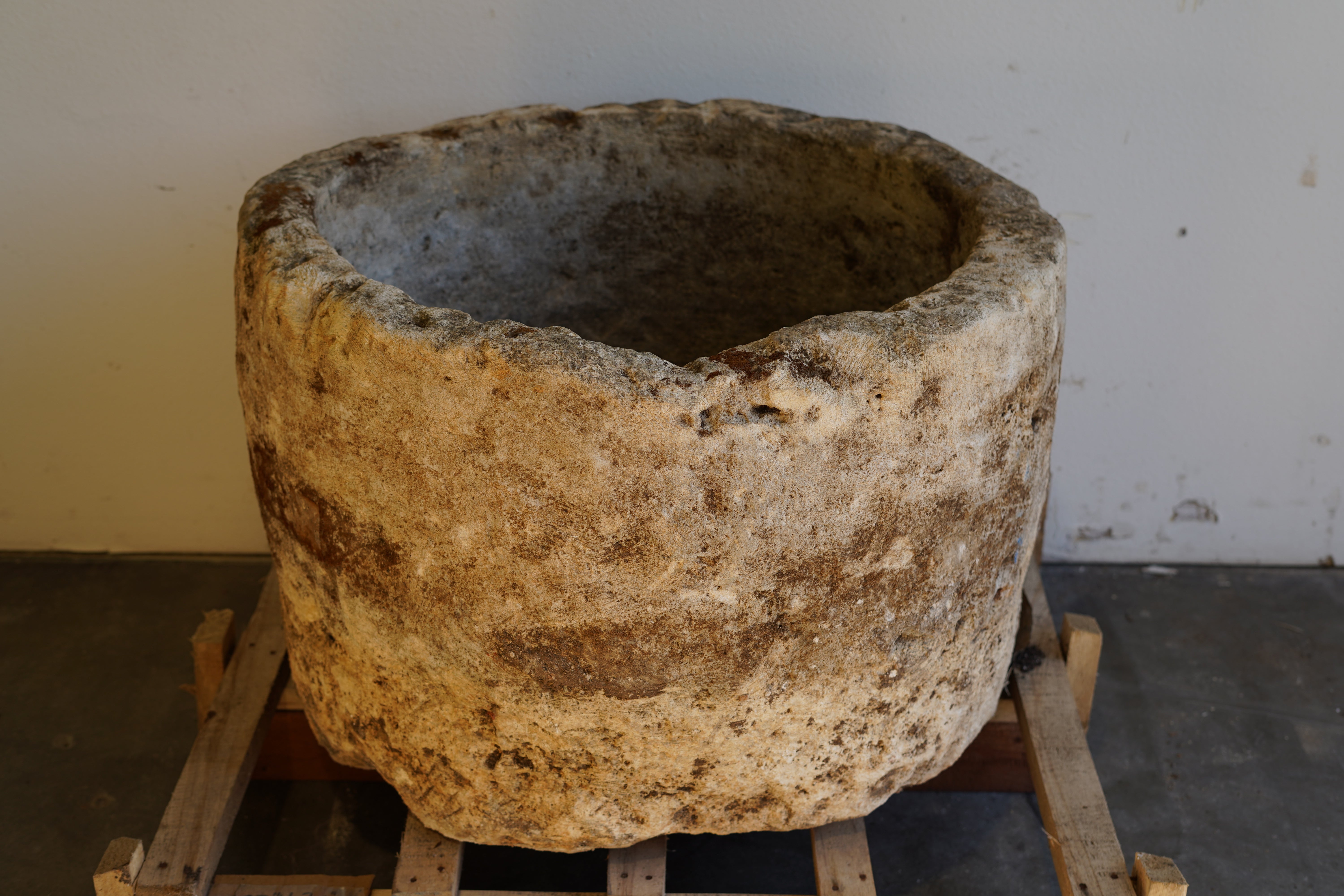 Backside view of Antique Hand Carved Limestone Round Planter 34" D x 22" H with natural aging, patina and character.