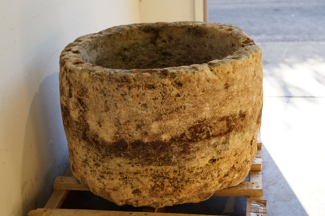 Side view of Antique Hand Carved Limestone Round Planter 34" D x 22" H with natural aging, patina and character.
