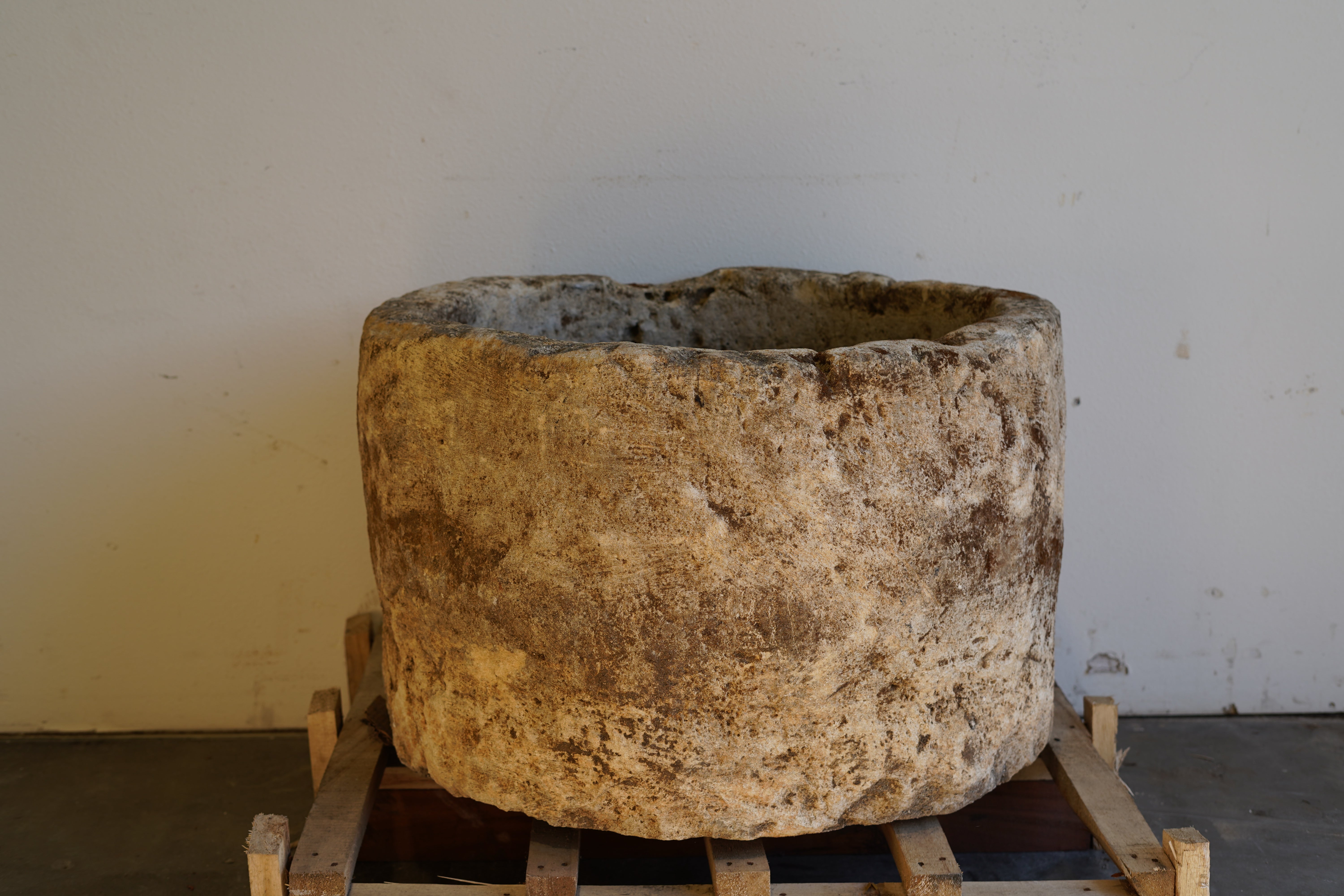 backside of Antique Hand Carved Limestone Round Planter 34" D x 22" H with natural aging, patina and character.