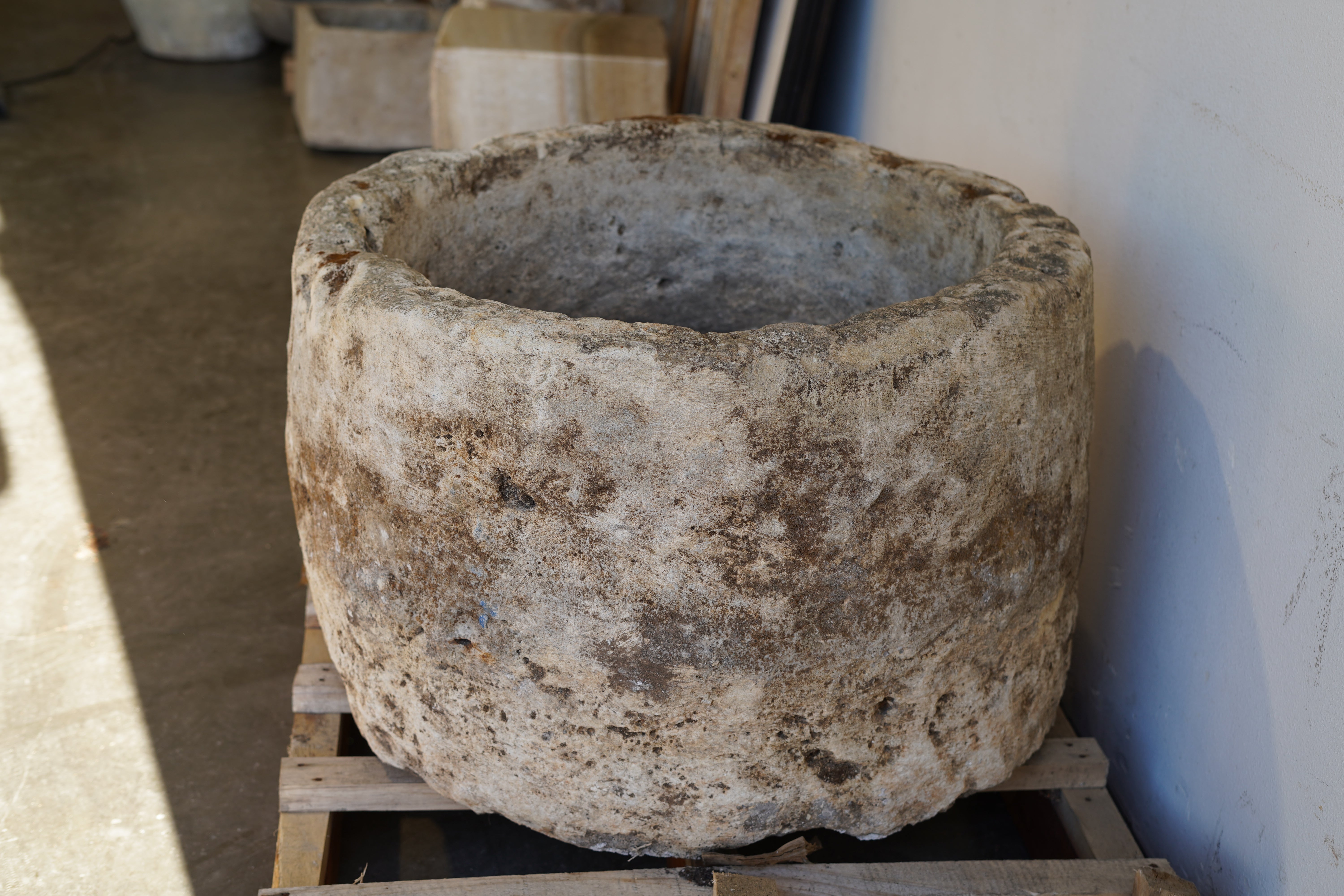 Side view of Antique Hand Carved Limestone Round Planter 34" D x 22" H with natural aging, patina and character.