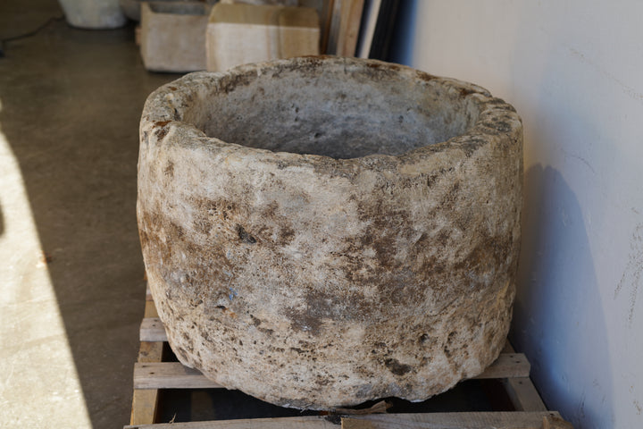 Side view of Antique Hand Carved Limestone Round Planter 34" D x 22" H with natural aging, patina and character.