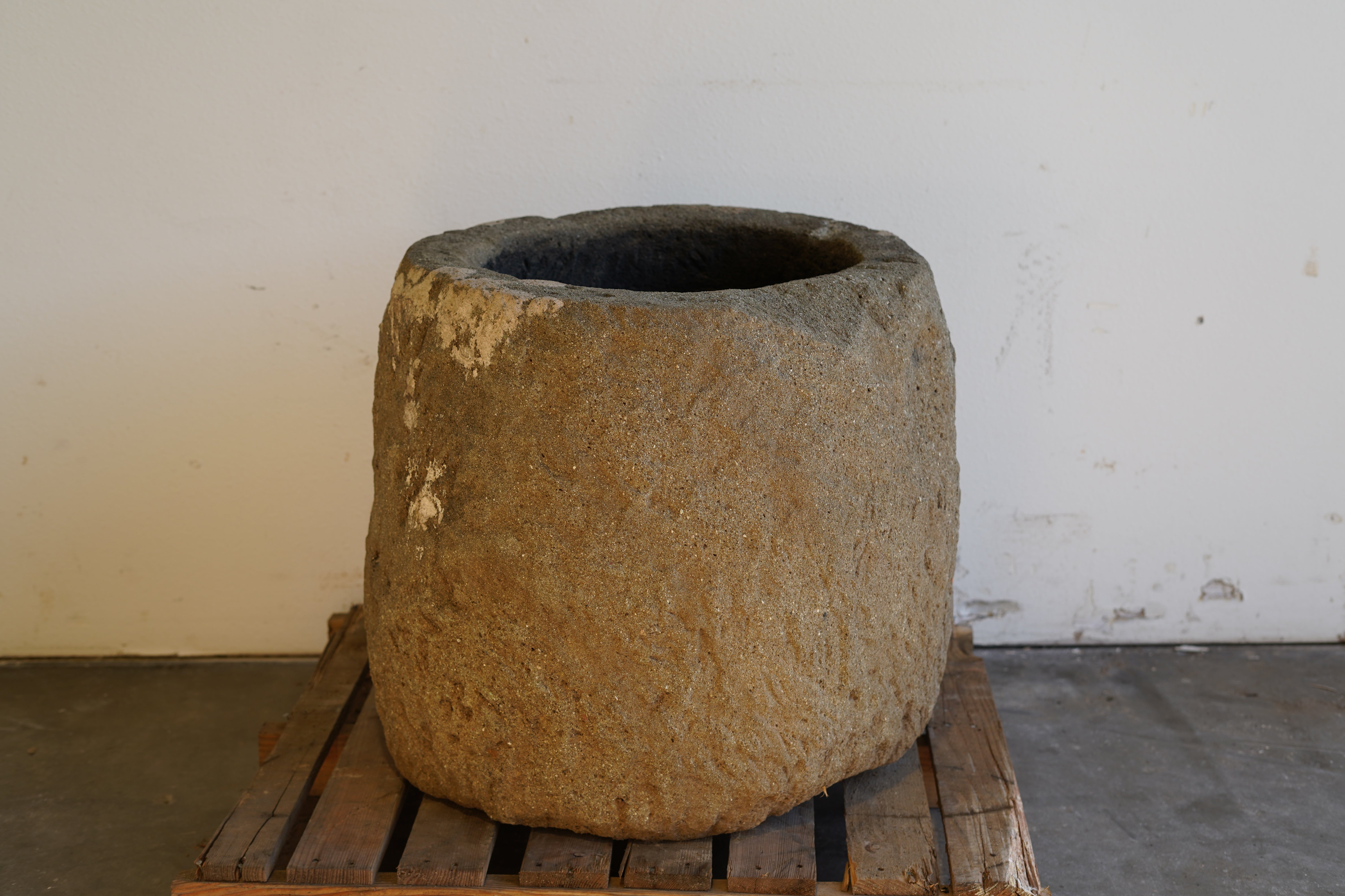 Alternative view of Tall Round Authentic Limestone Planter 25" D x 24" H in natural sunlight.