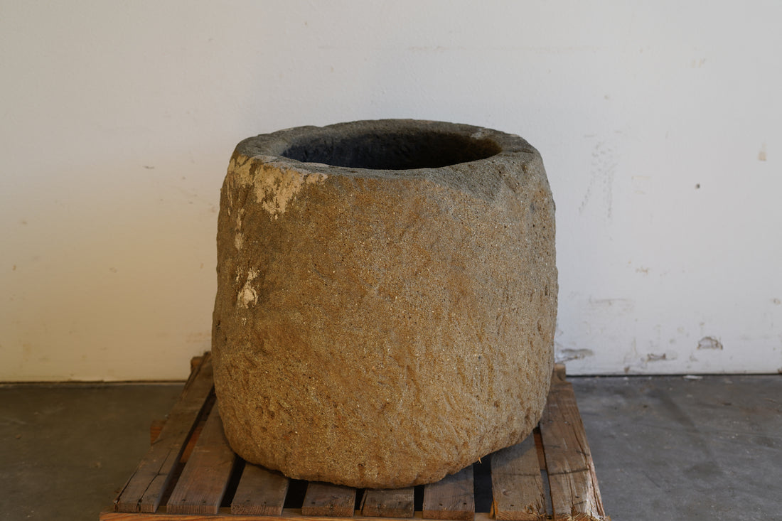 Alternative view of Tall Round Authentic Limestone Planter 25" D x 24" H in natural sunlight.