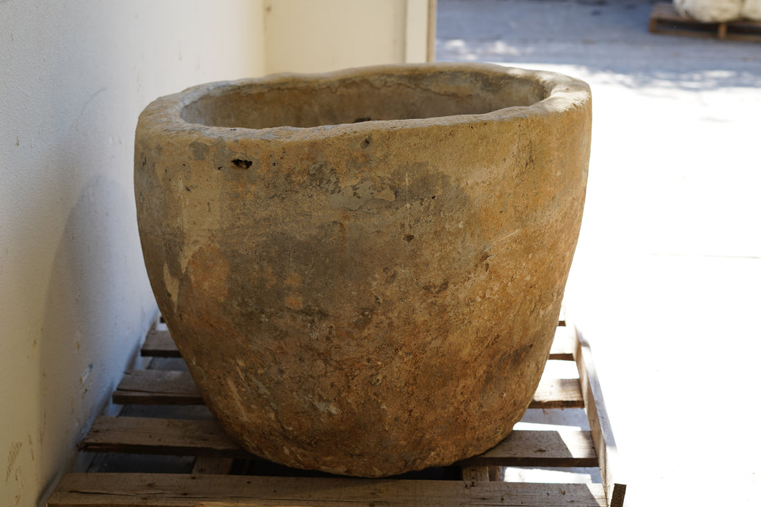Side view of Vintage Limestone Planter with rare character of uneven lip edge - Round. Dimensions: 23" H x 30" D. 