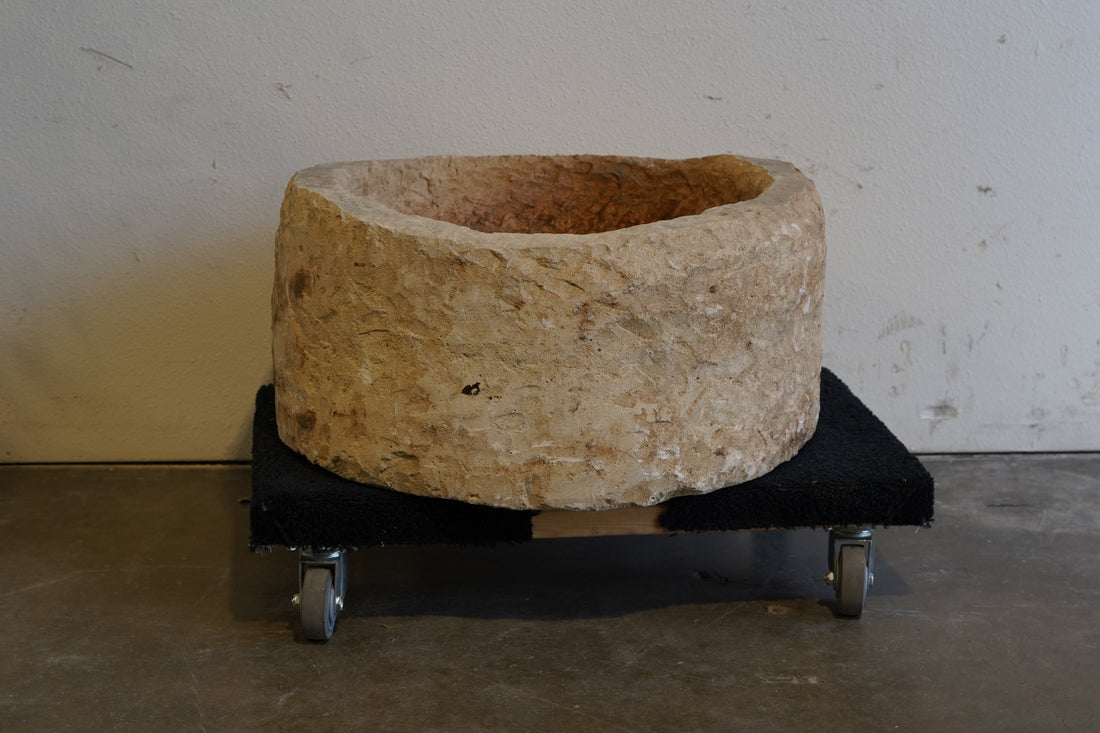 Vintage limestone planter with natural wear and tear from years of use.