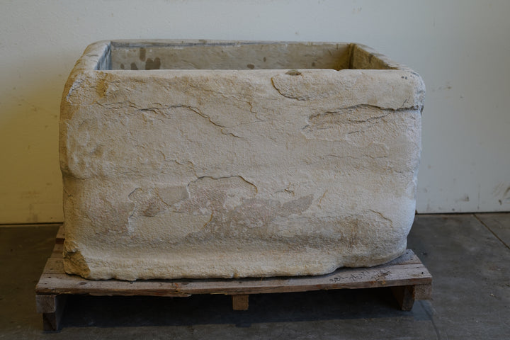 Vintage limestone planter trough with natural patina, shown in outdoor garden setting – 38 inches long by 26 wide by 23 high
