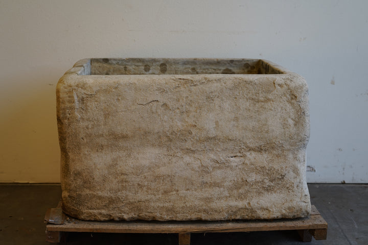 Antique limestone planter with unique aging marks and hand-carved form