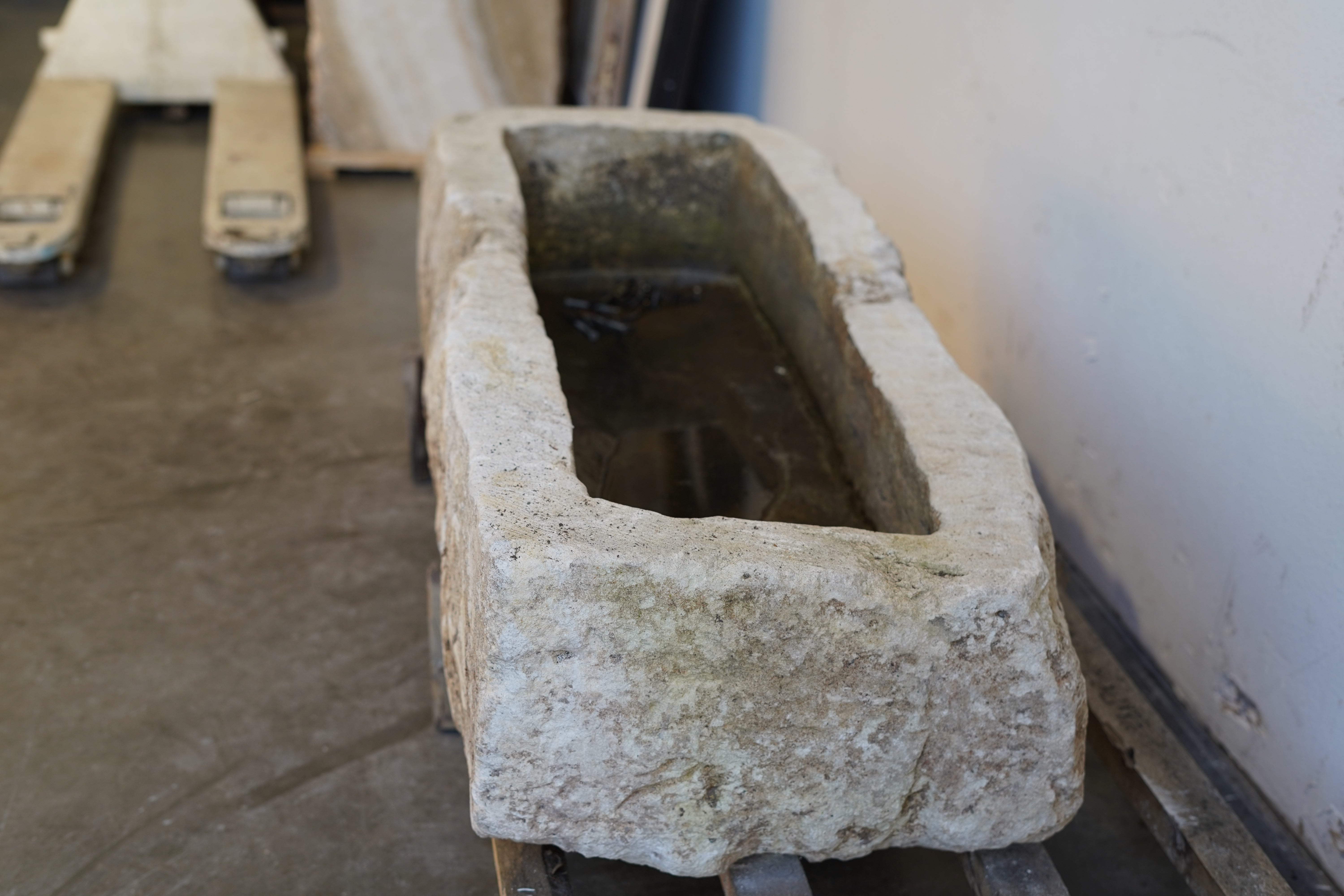 Close-up of vintage limestone garden planter showing hand-carved detail and natural aging