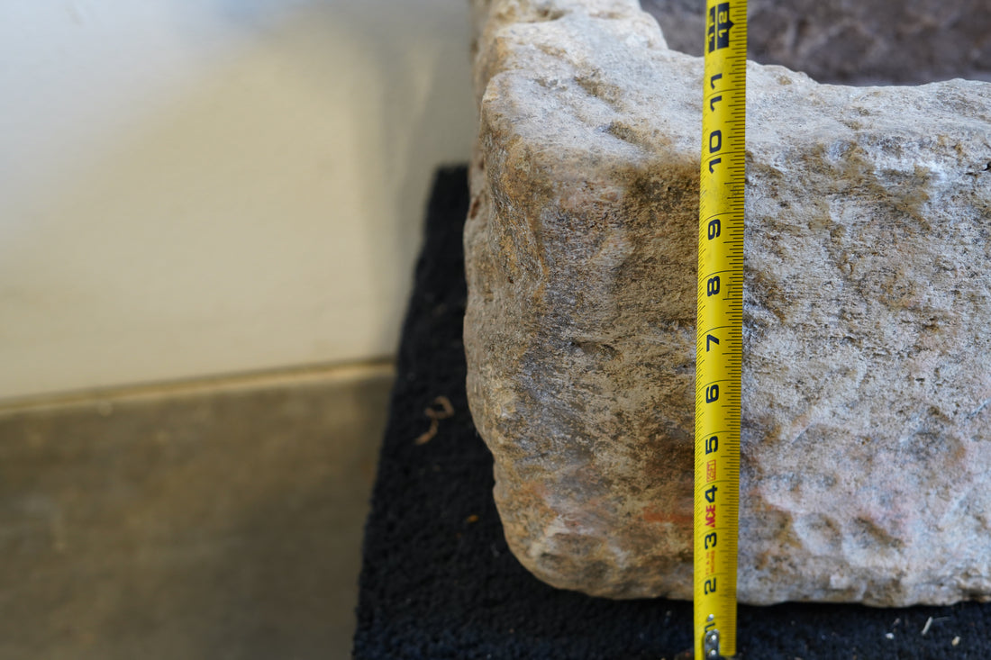 Close up view of natural patina on vintage limestone trough.