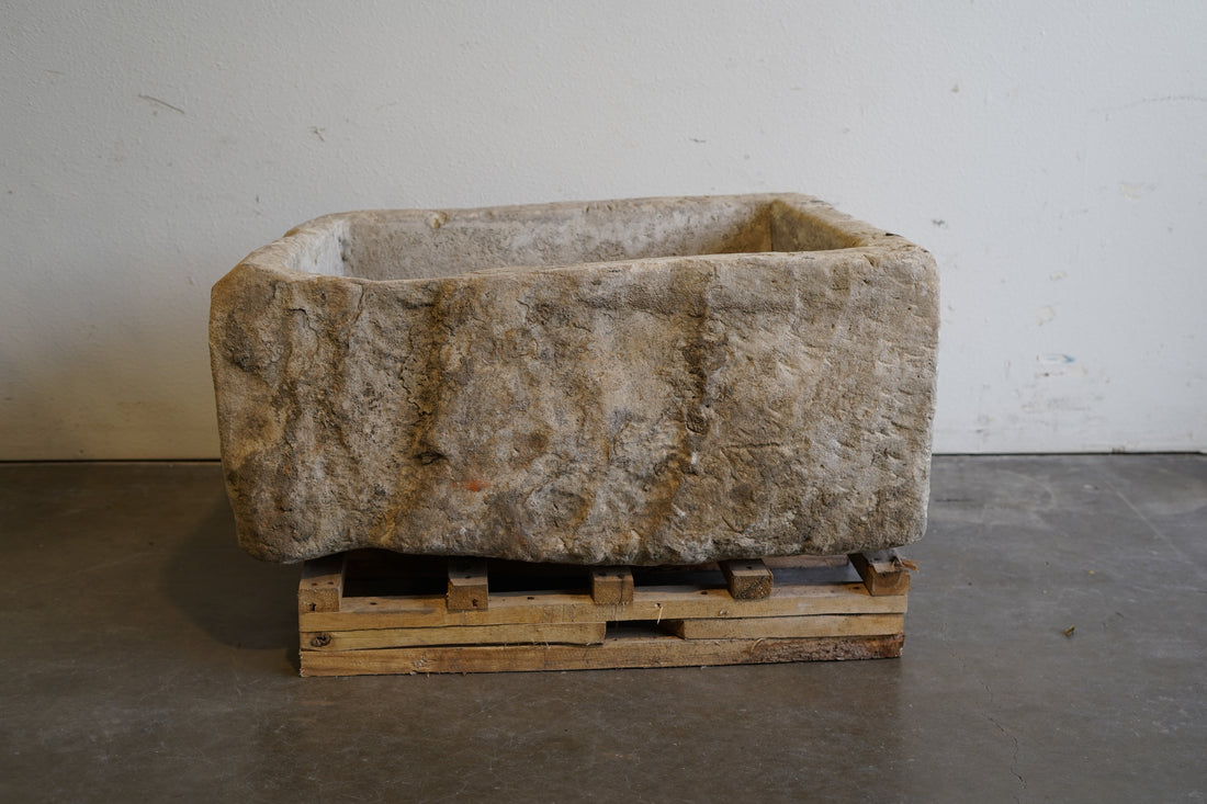backside of Vintage hand-carved limestone trough. 