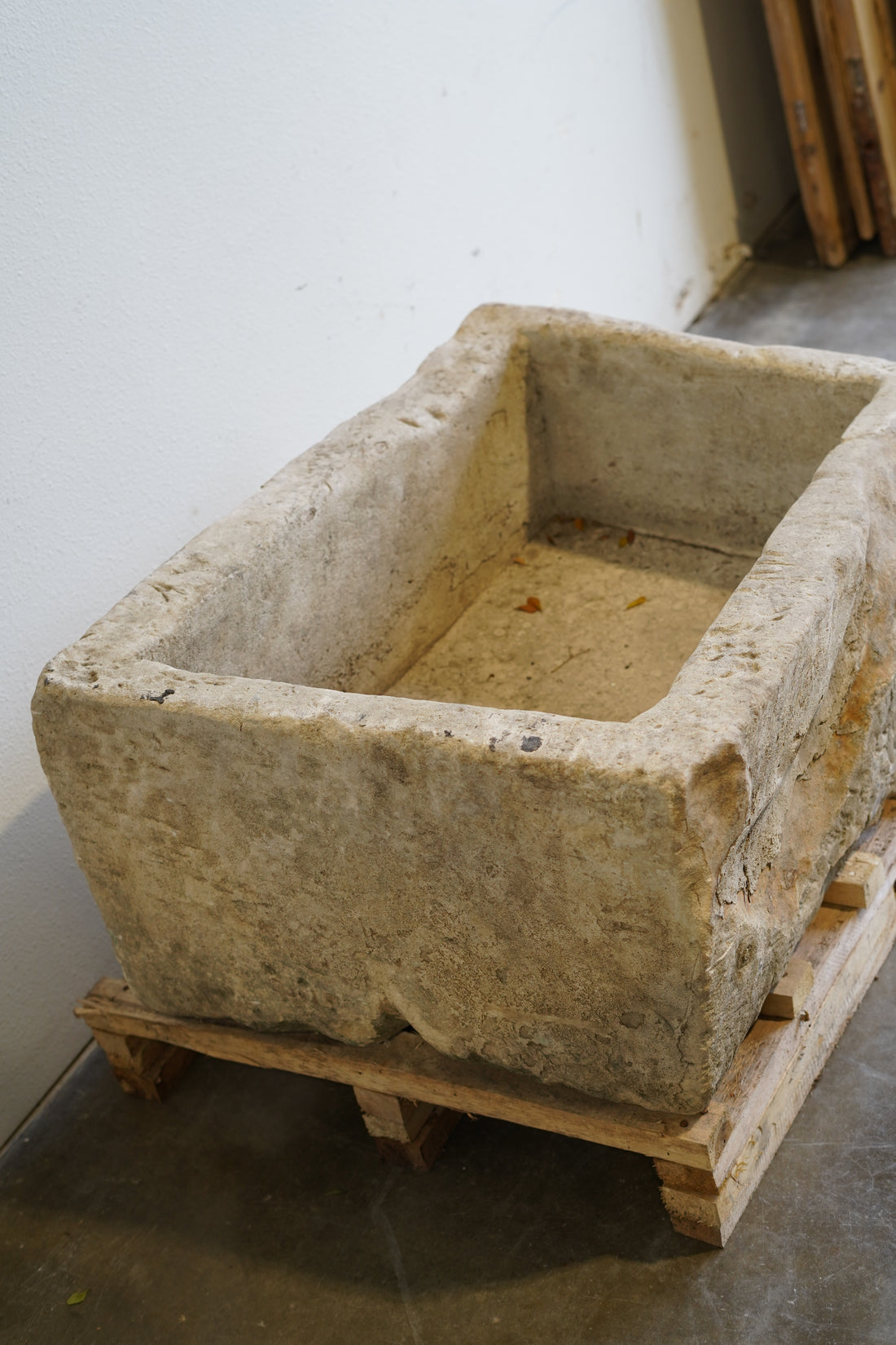 Side view of Vintage hand-carved limestone trough. 