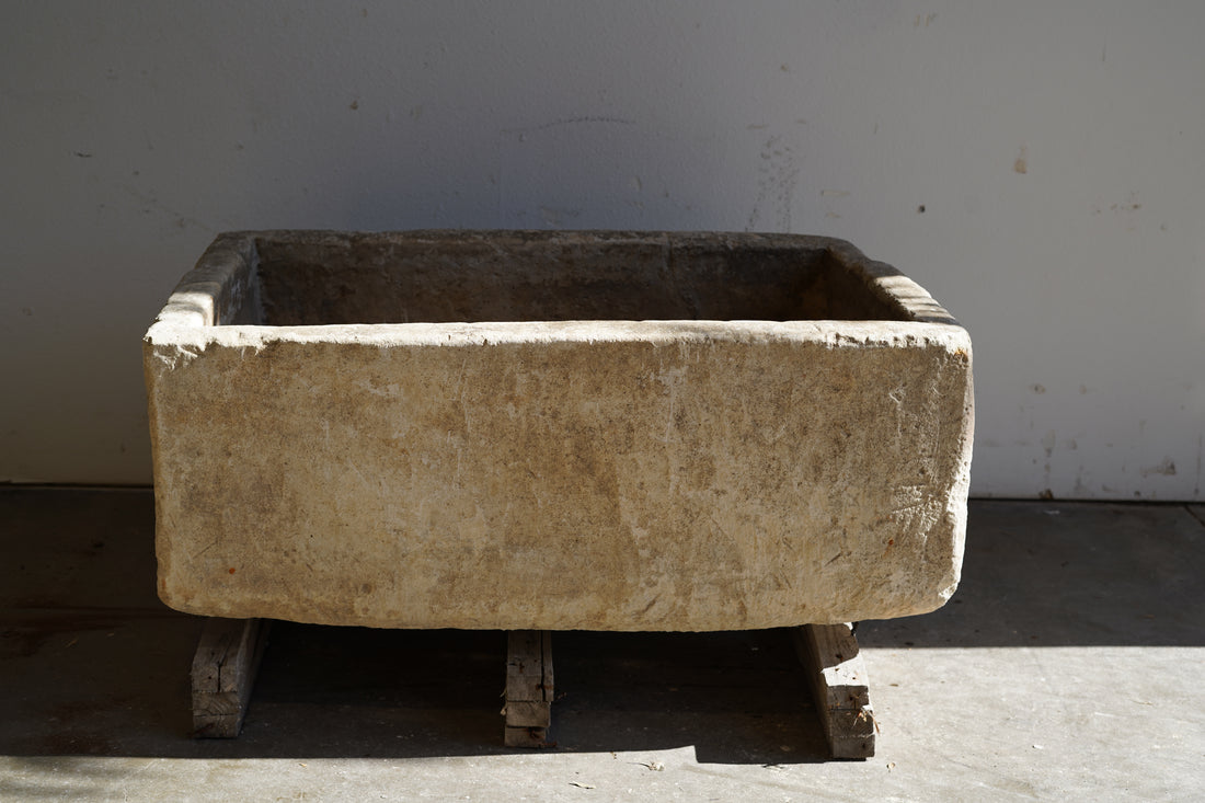Backside view of Vintage Limestone Trough in natural lighting. Dimensions: 37.5" L x 25" W x 16.5" H
