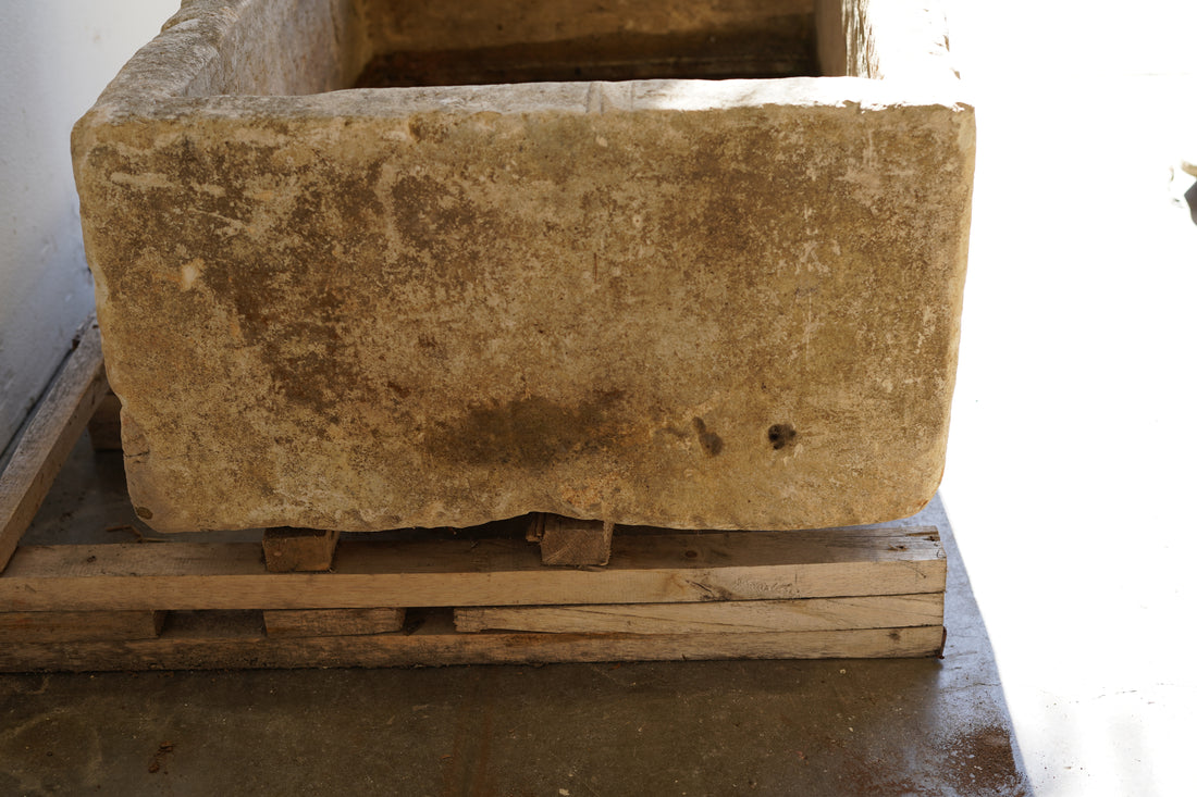 Close up side view of Vintage Limestone Trough in natural lighting. Dimensions: 37.5" L x 25" W x 16.5" H