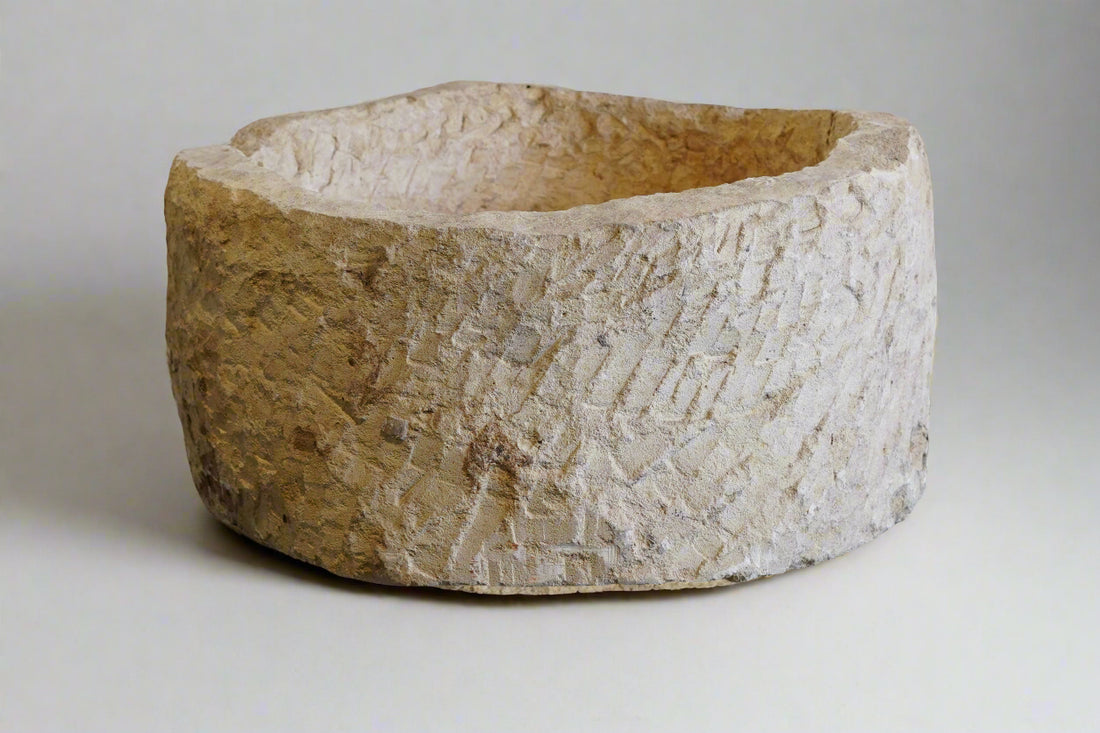 Vintage limestone planter round shape. 26" w x 14" H with plain white backdrop. uneven edges from natural wear and use over decades.