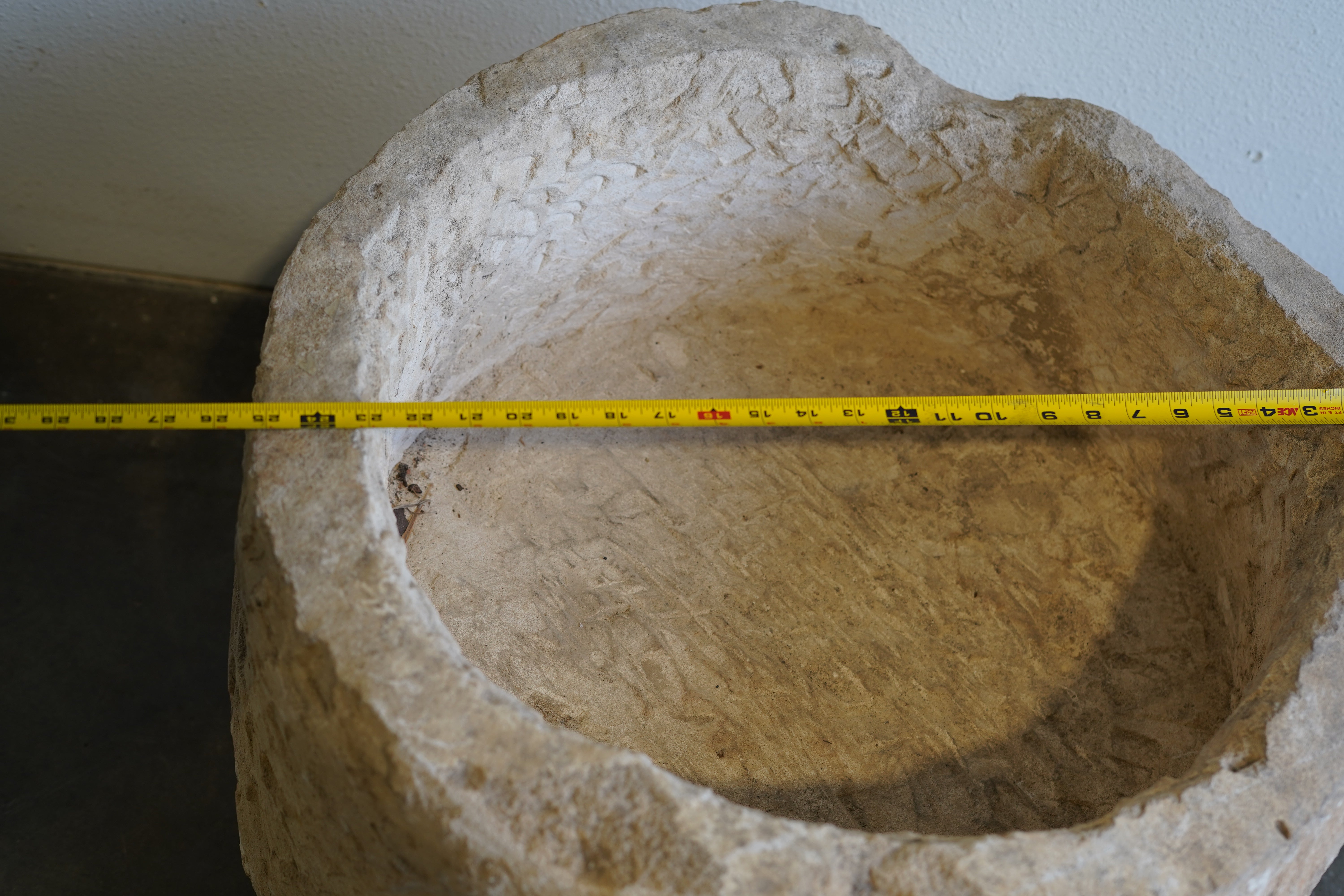 Close up top down view of vintage round authentic limestone planter. 