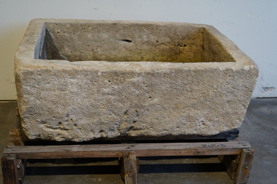backside of vintage rectangular limestone trough planter with natural patina, hand-carved and ideal for outdoor gardens or rustic indoor decor, 39L x 29W x 15H inches.