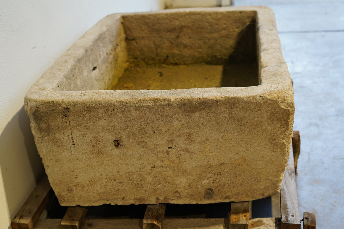 side view of Vintage rectangular limestone trough planter with natural patina, hand-carved and ideal for outdoor gardens or rustic indoor decor, 39L x 29W x 15H inches.