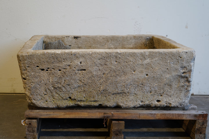 Vintage rectangular limestone trough planter with natural patina, hand-carved and ideal for outdoor gardens or rustic indoor decor, 39L x 29W x 15H inches.